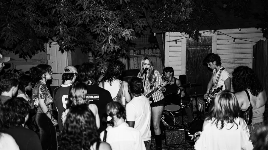 Wide shot of a Lady Preacher backyard show, black and white