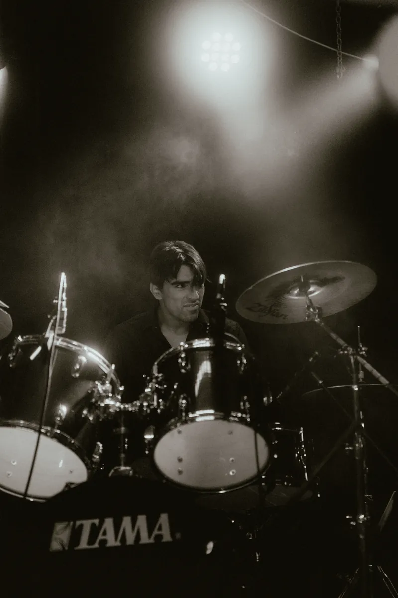 Mateo on drums, in black and white