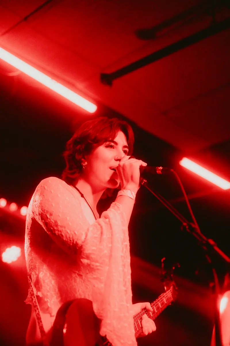 Gavriella singing in red light