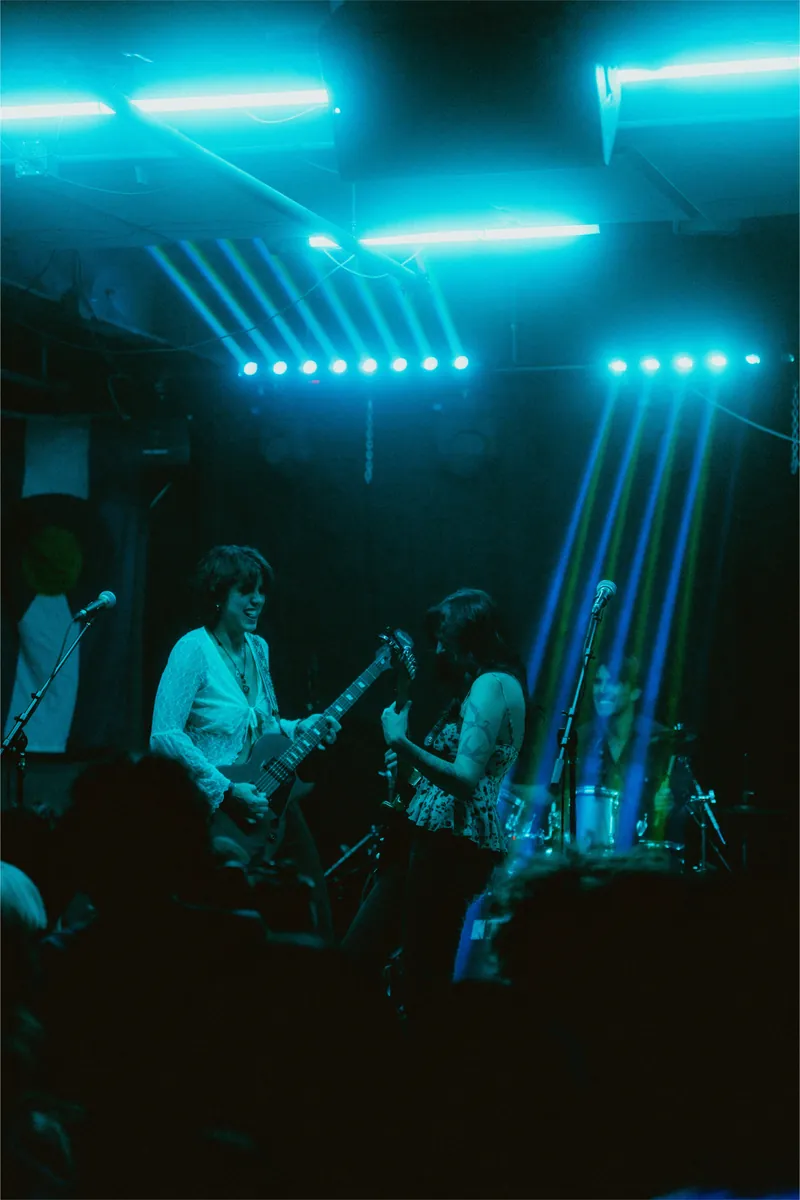 The band under blue stage beams