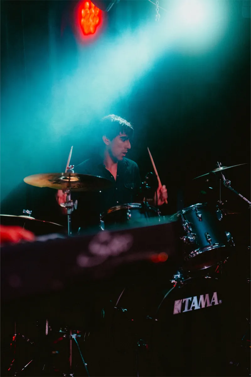 Mateo on drums in teal haze